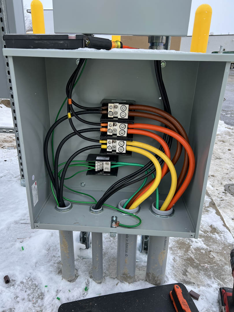 Open junction box with organized conductors and terminal connections