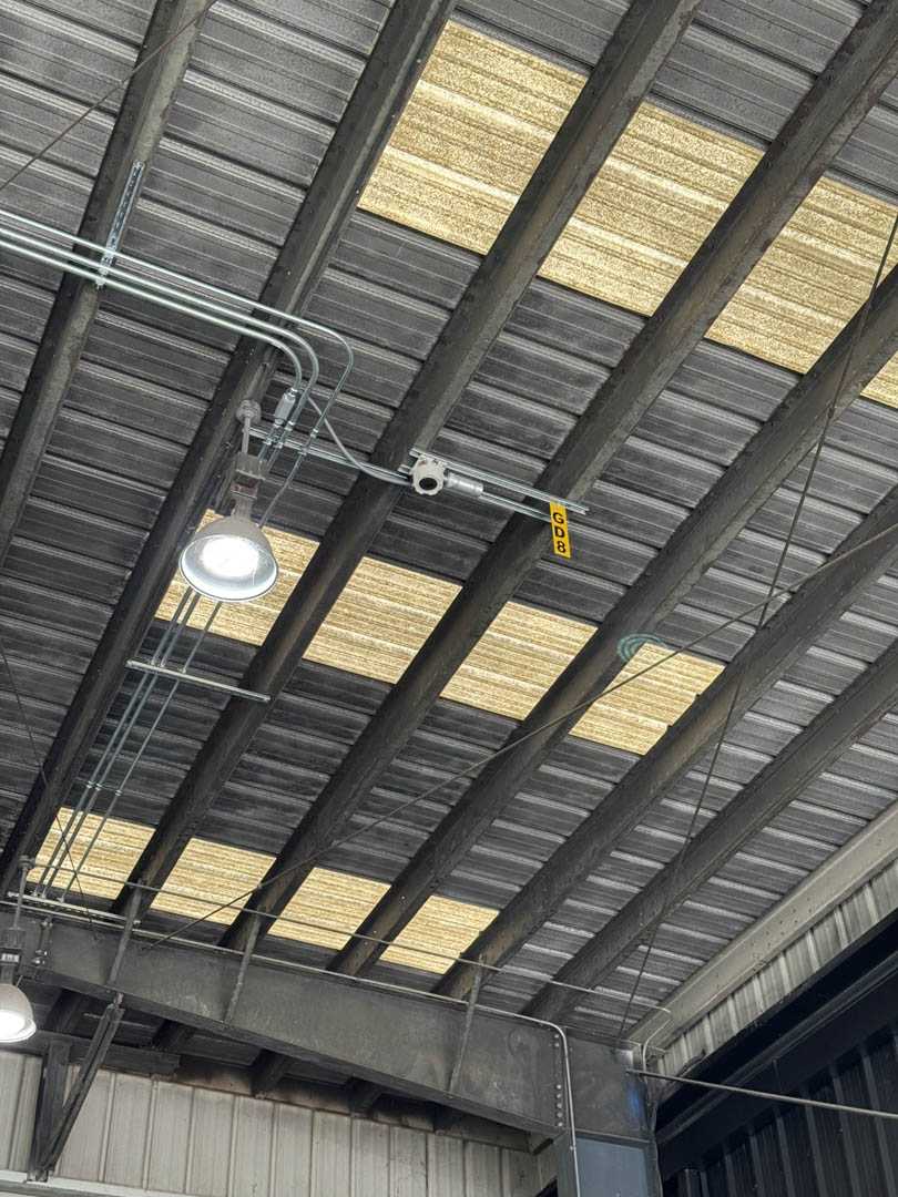 Ceiling-mounted wiring and detection equipment in an industrial bay