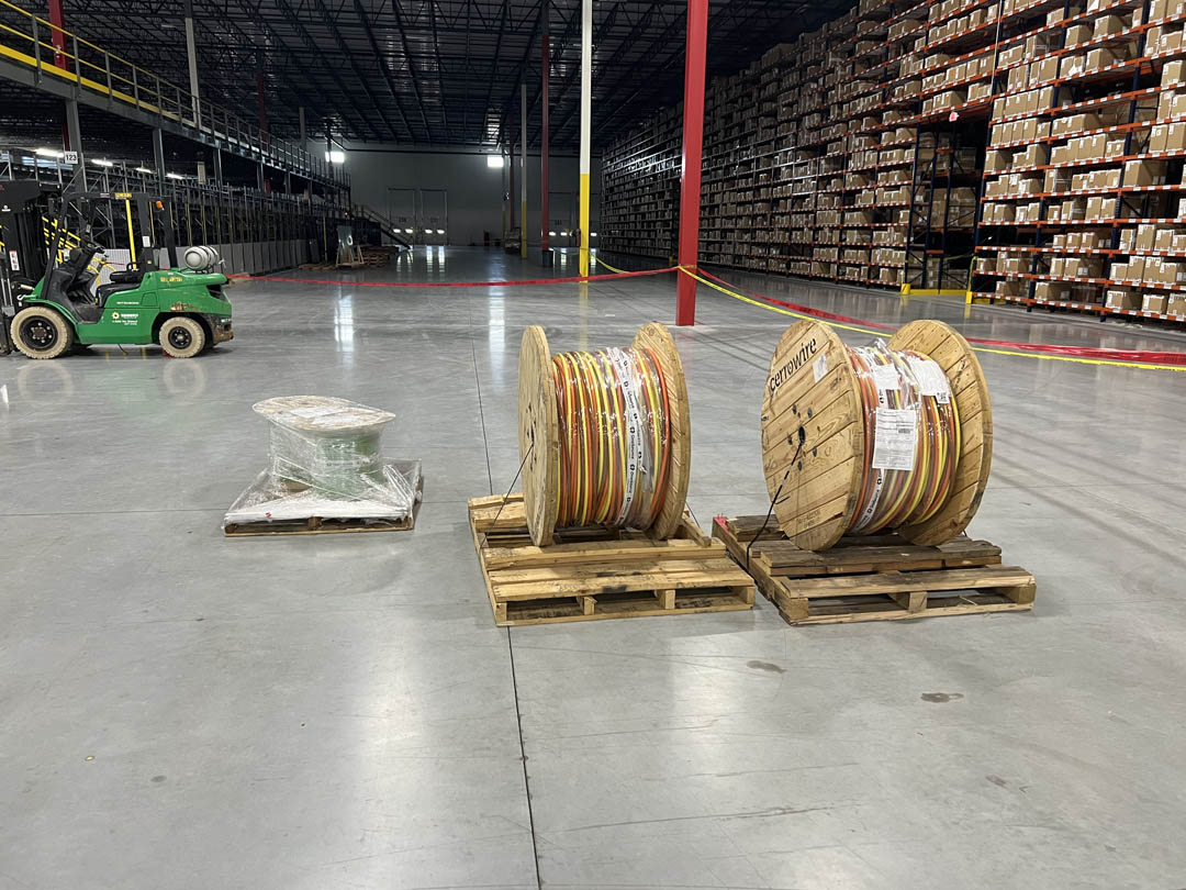 Cable reels staged on a warehouse floor for electrical installation