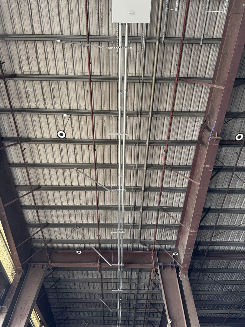 Electrical conduit routed along the underside of a covered structure