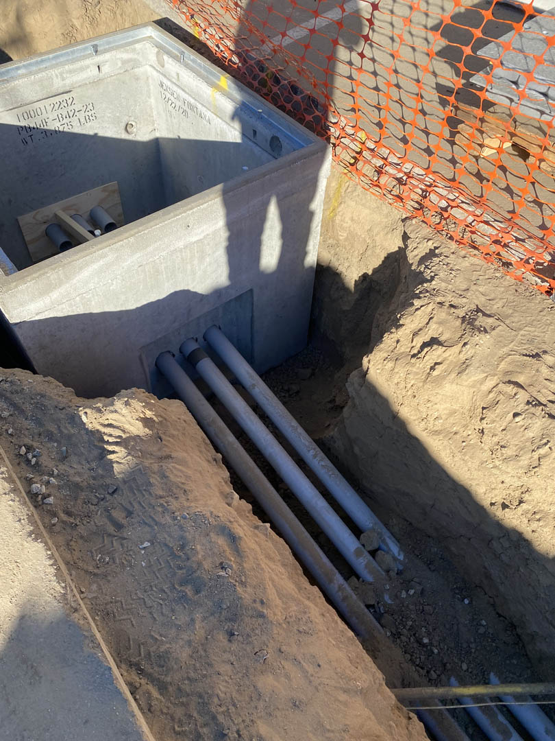 Underground conduit bank exposed in a trench