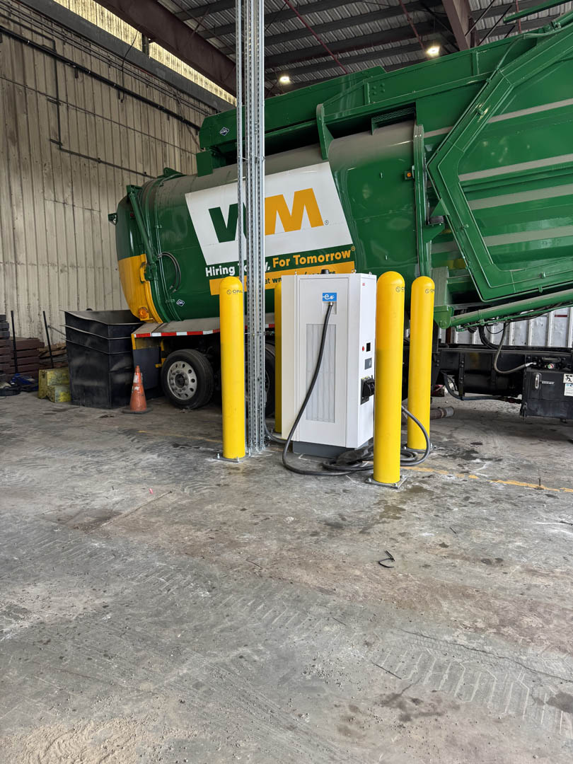 EV charging pedestal beside industrial fleet equipment