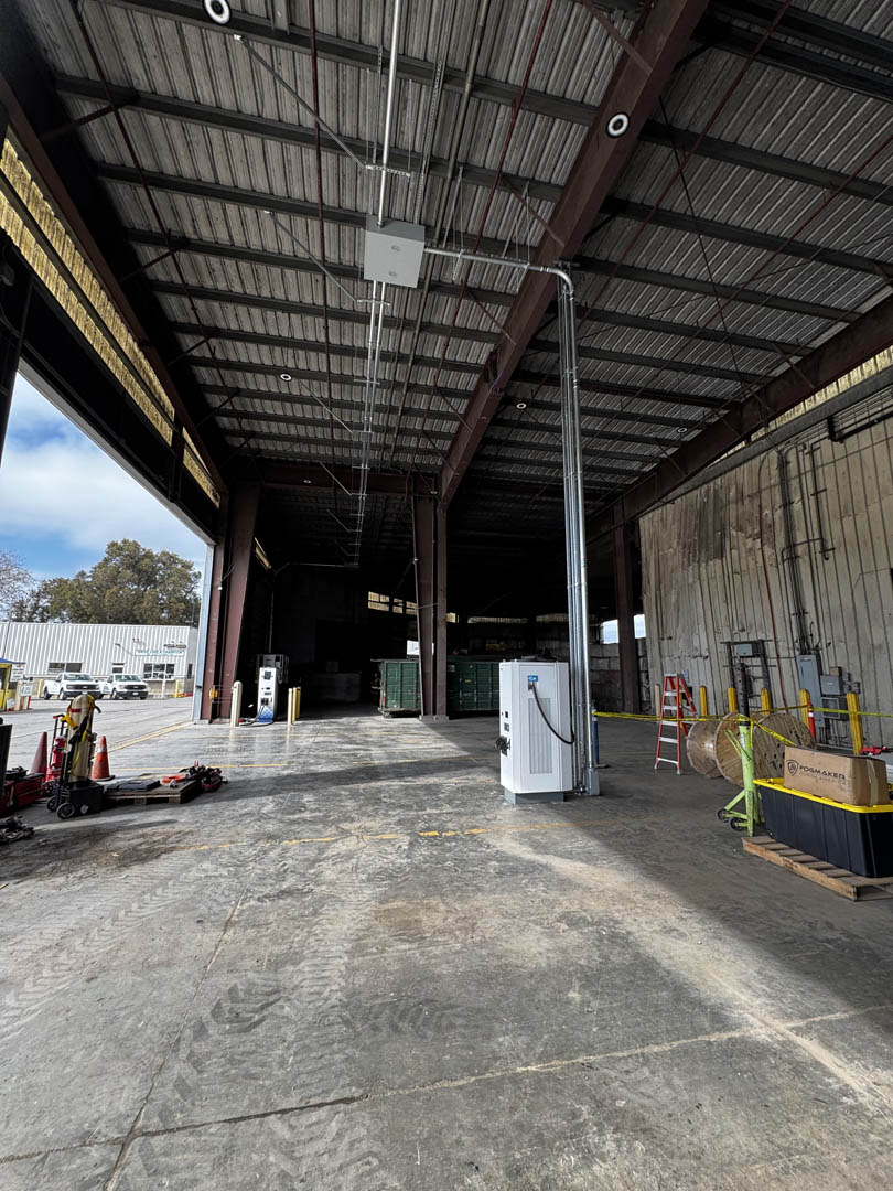 Covered industrial bay with electrical equipment mounted near the wall