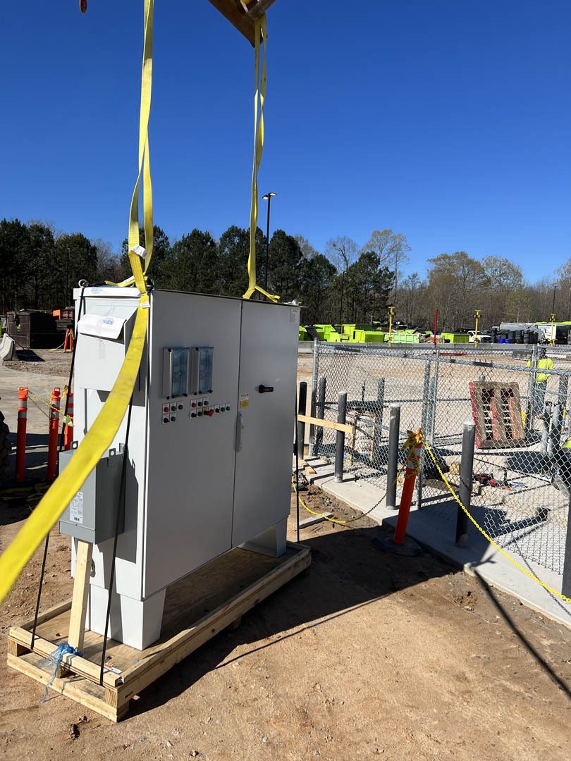 Electrical service cabinet mounted on a concrete pad at an outdoor facility