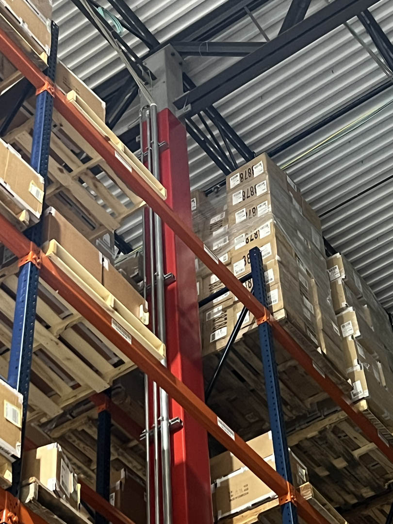 Pallet racking with overhead conveyor and electrical infrastructure