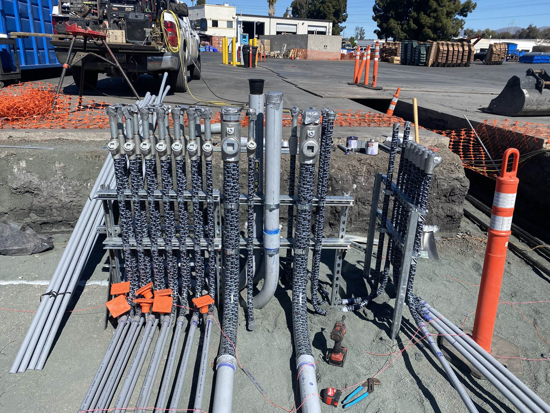 Conduit stubs and wiring organized for an outdoor equipment pad