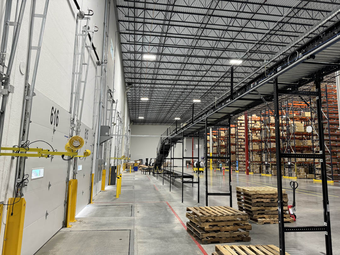 Warehouse wall with conduit and conveyor-related electrical work