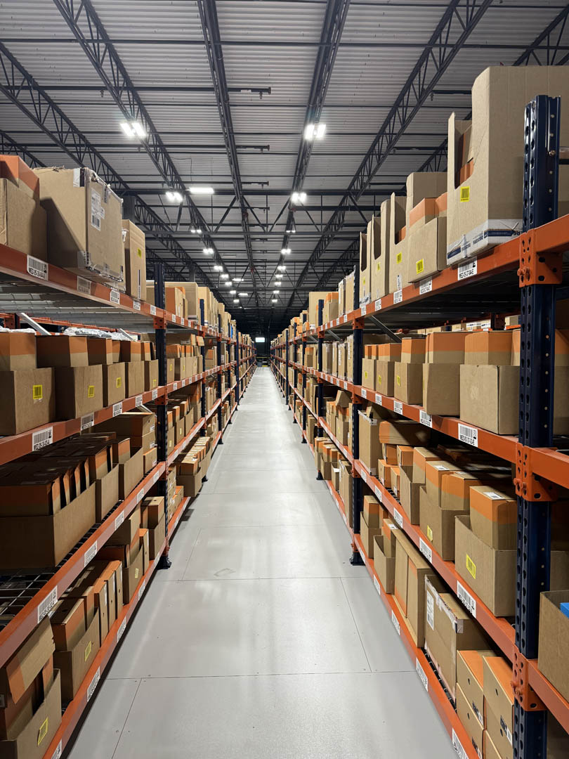 High-bay lighting installed over warehouse storage racks